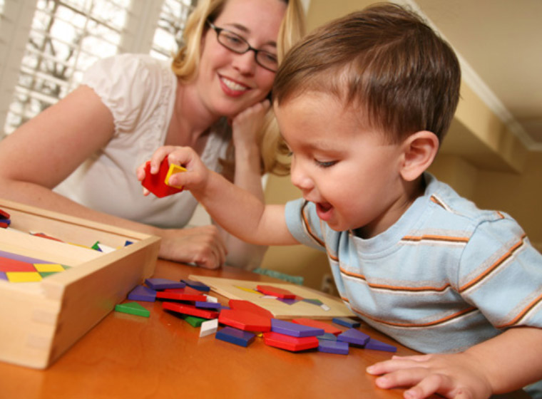 photo of mom with toddler doing puzzle